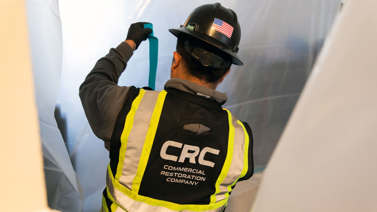 CRC employee setting up mold containment area inside an apartment unit.