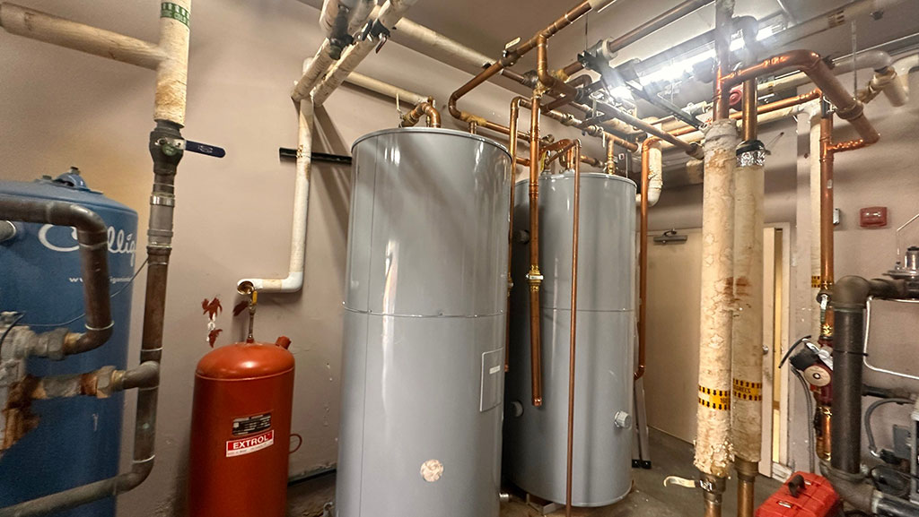 Water heaters in mechanical room of commercial building.
